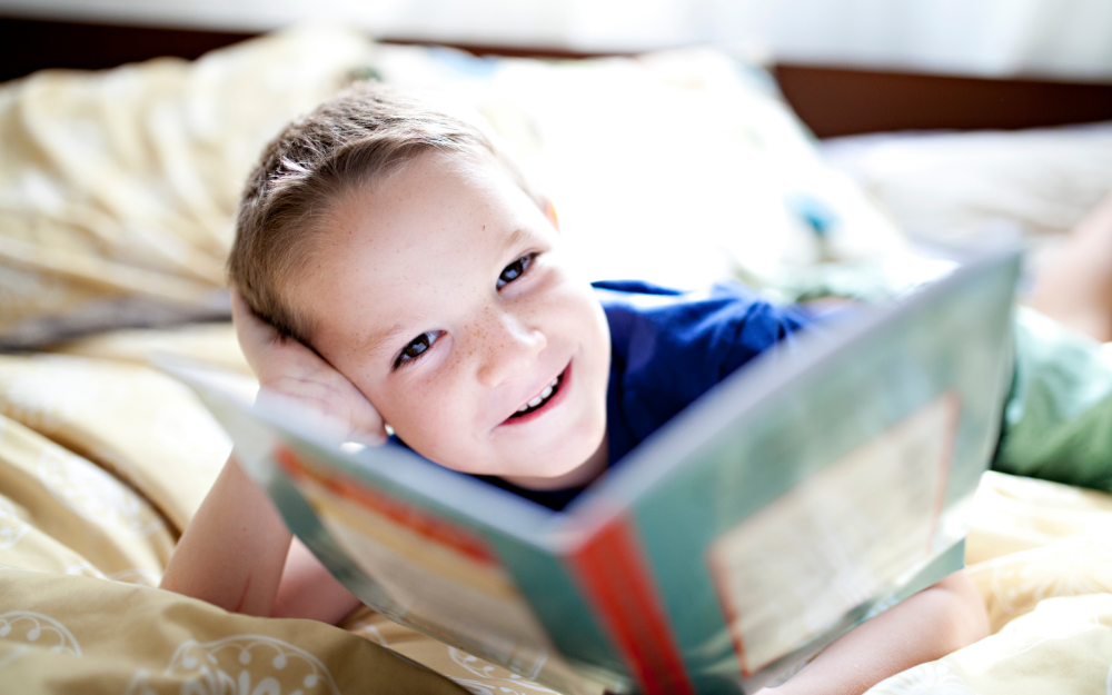 Child reading book about social emotional skills. 