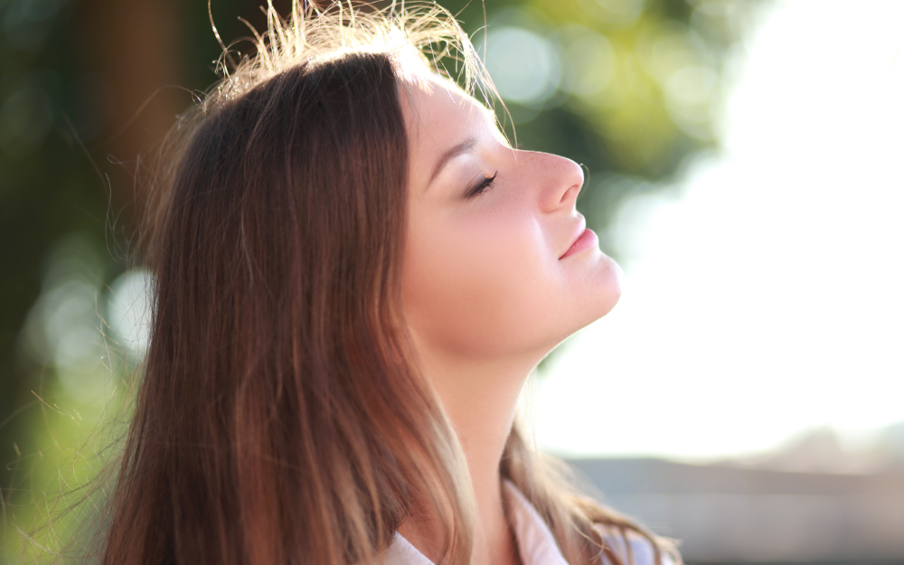 Adult taking a deep breath, using a coping skill. 