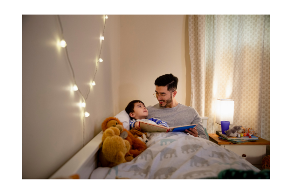 Parent reading with child, setting a night time routine