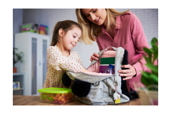 Child packing back pack for back to school. 