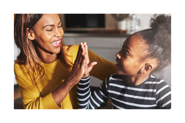 Parent high fiving child for using good social skills. 