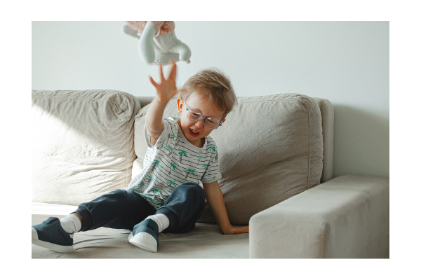 Child learning functional communication strategies to reduce interfering behaviors of throwing. 